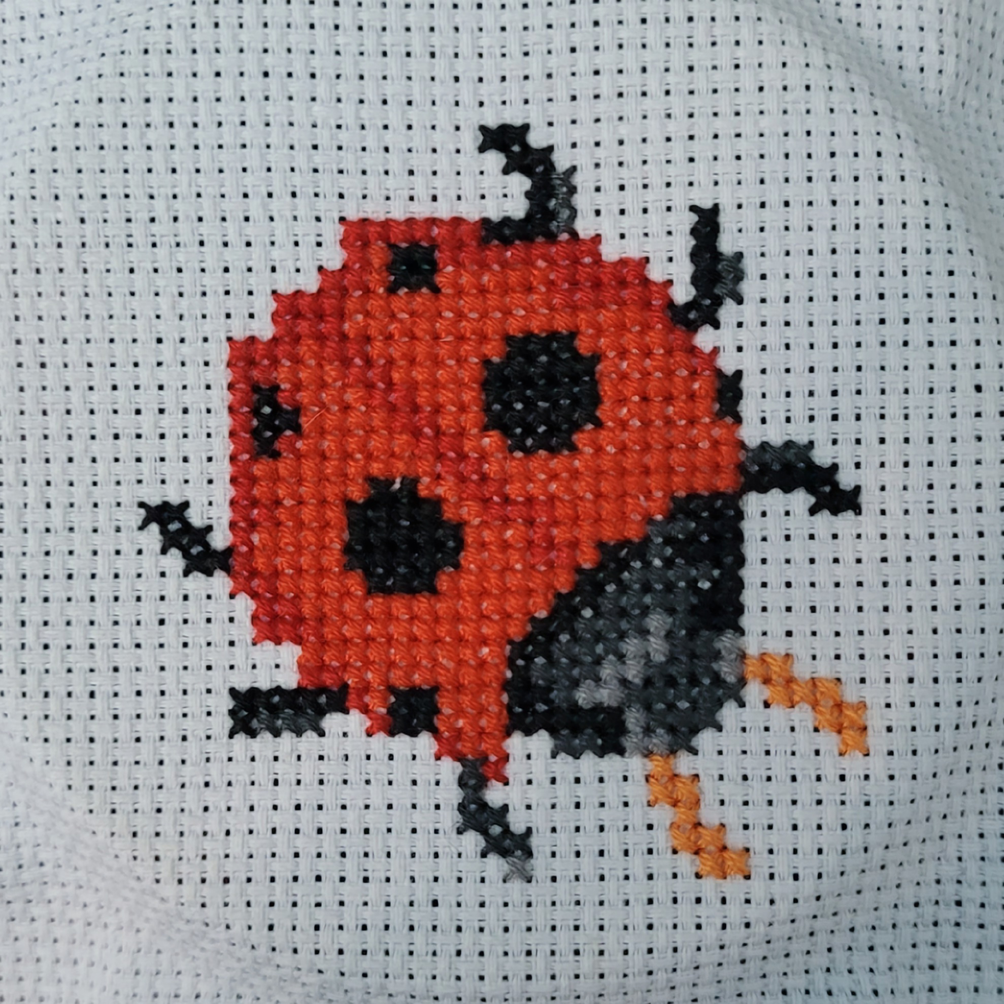 Cross stitching of a ladybug