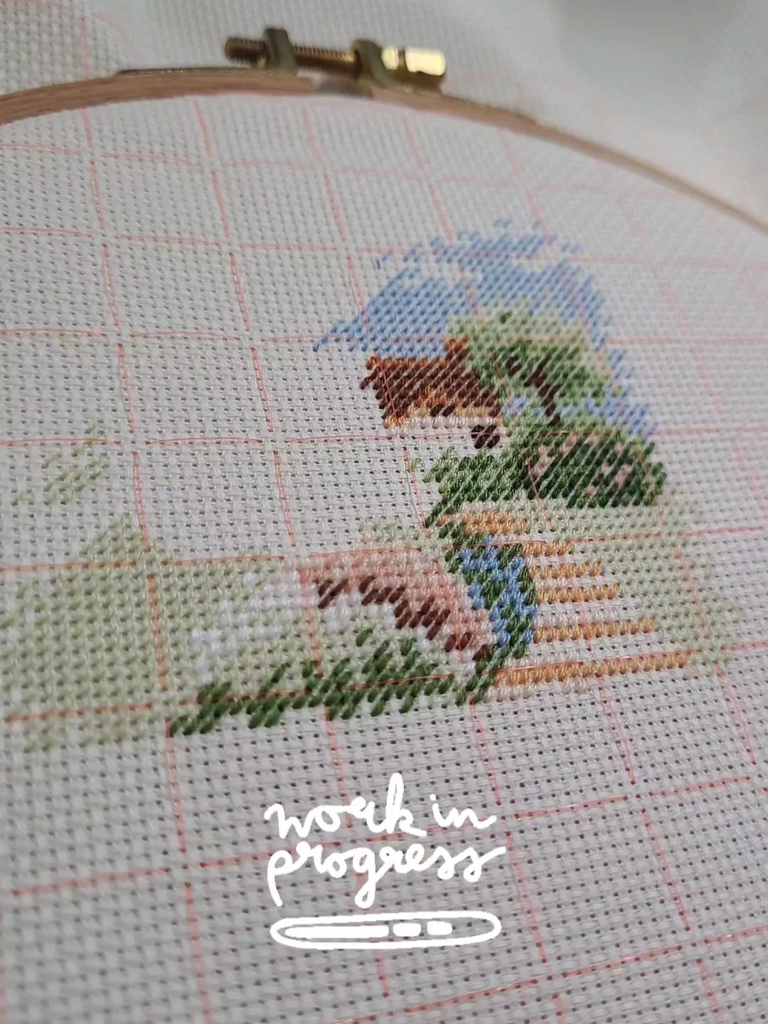 Unfinished cross stitching of a house